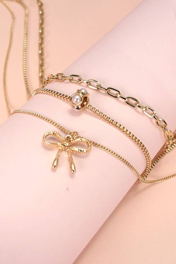 MULTI LAYER PEARL BOW CAHRM NECKLACE |