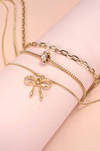 MULTI LAYER PEARL BOW CAHRM NECKLACE |