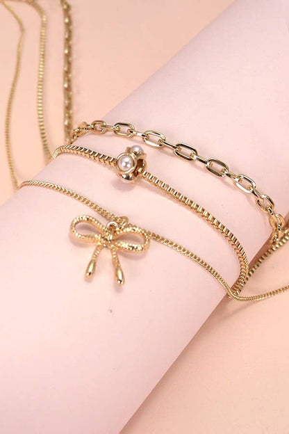MULTI LAYER PEARL BOW CAHRM NECKLACE |