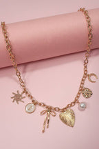 SUN BOW PEARL CROSS DISC U CHARM NECKLACE
