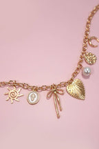 SUN BOW PEARL CROSS DISC U CHARM NECKLACE