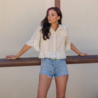 Distressed Denim Crop Jacket with Ruffled Hem