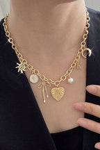 SUN BOW PEARL CROSS DISC U CHARM NECKLACE